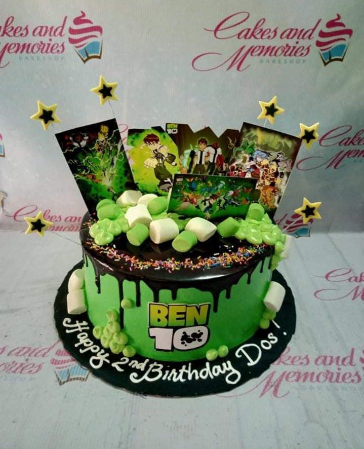 Ben 10 themed birthday cake with green icing, chocolate drip, and character printouts for a 2nd birthday celebration.