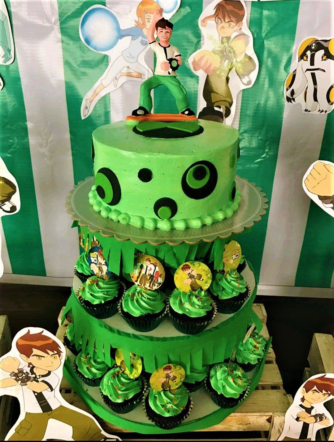 Ben 10 themed green cake with black circular patterns and a Ben 10 figurine on top, surrounded by matching cupcakes.