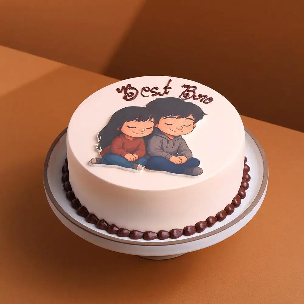 Minimalist white round cake with a cute brother and sister cartoon printout and brown icing message 'Best Bro' on top.