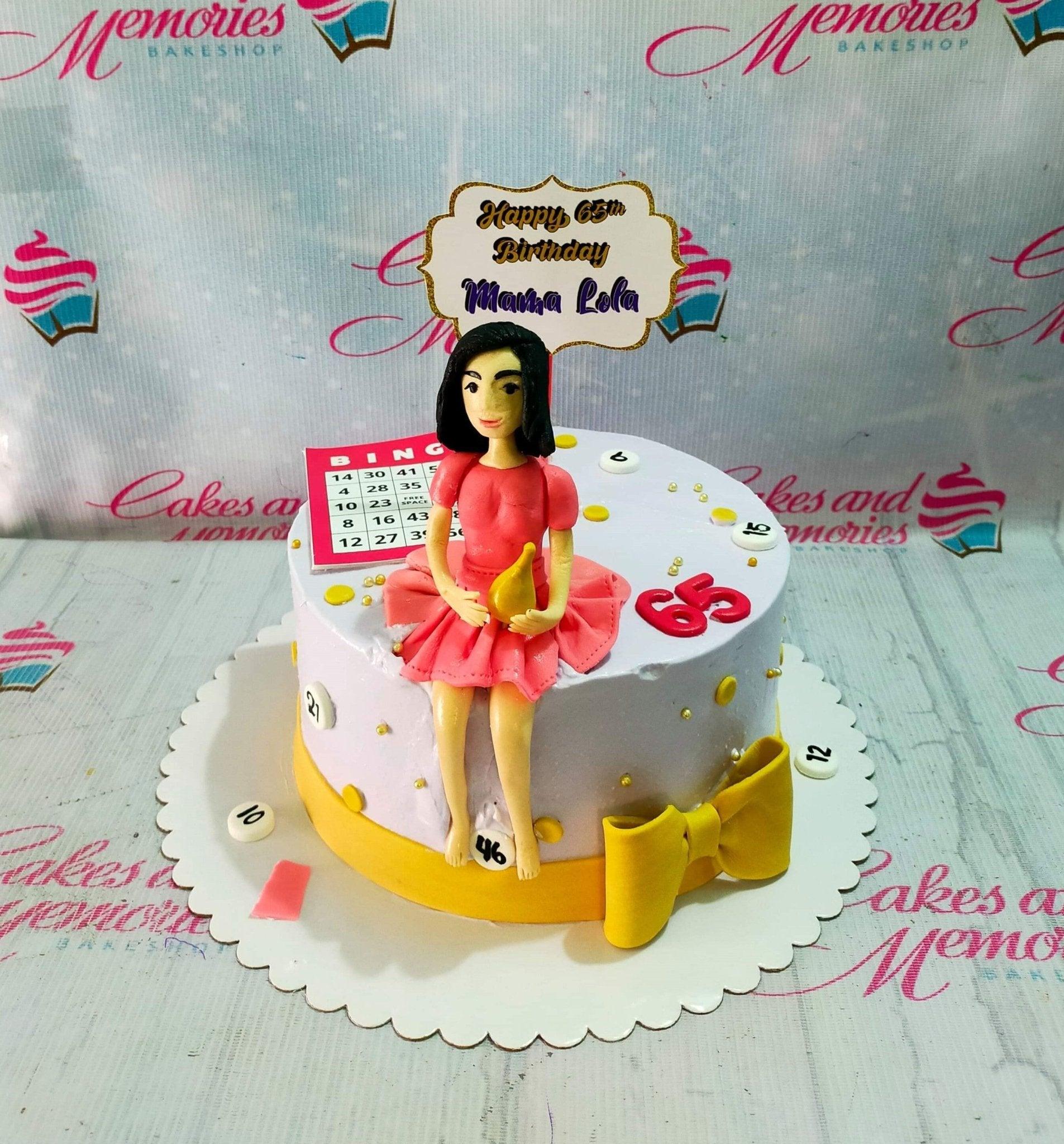 Light purple 65th birthday cake for Mama Lola featuring a bingo theme with a fondant woman figure, bingo card, and yellow bow.