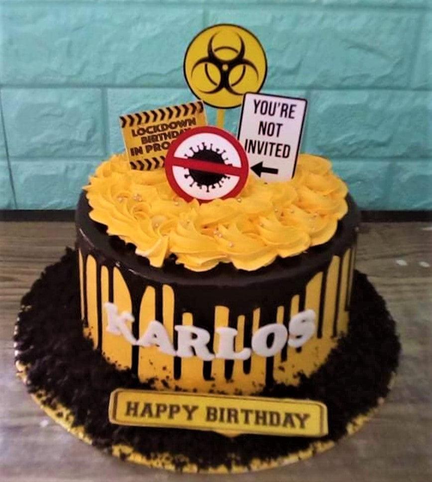 Yellow and black biohazard themed birthday cake with chocolate drip and quarantine sign toppers.