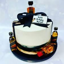 Black gold, Liquor birthday 1 Tier - black, gold, dark theme with black gumpaste bow and black and gold striped edible wrap