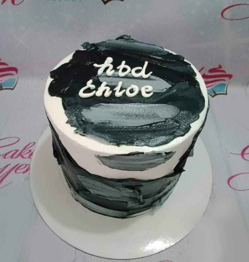 Minimalist black and white bento cake with textured palette knife icing and a handwritten birthday message for Chloe.