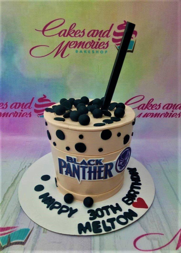 Black Panther themed boba tea cake with black pearls, a straw topper, and a Black Panther logo printout.