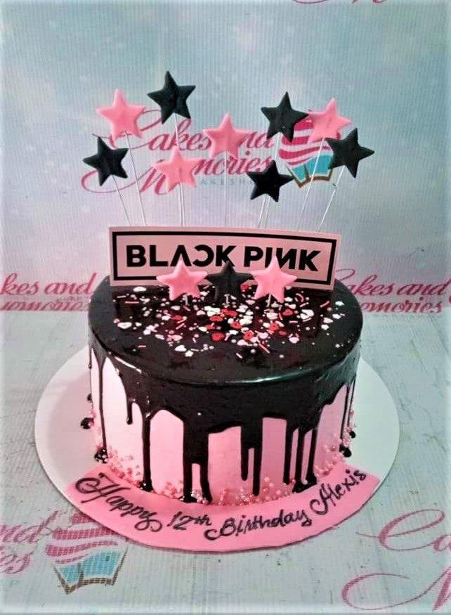 Blackpink themed birthday cake with pink icing, black chocolate drip, and star toppers.