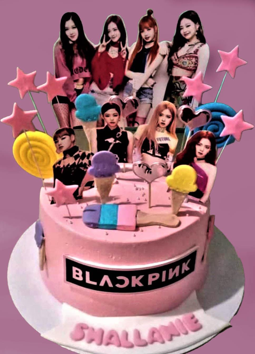 Pink Blackpink themed birthday cake with character printouts, fondant ice cream cones, and star toppers.