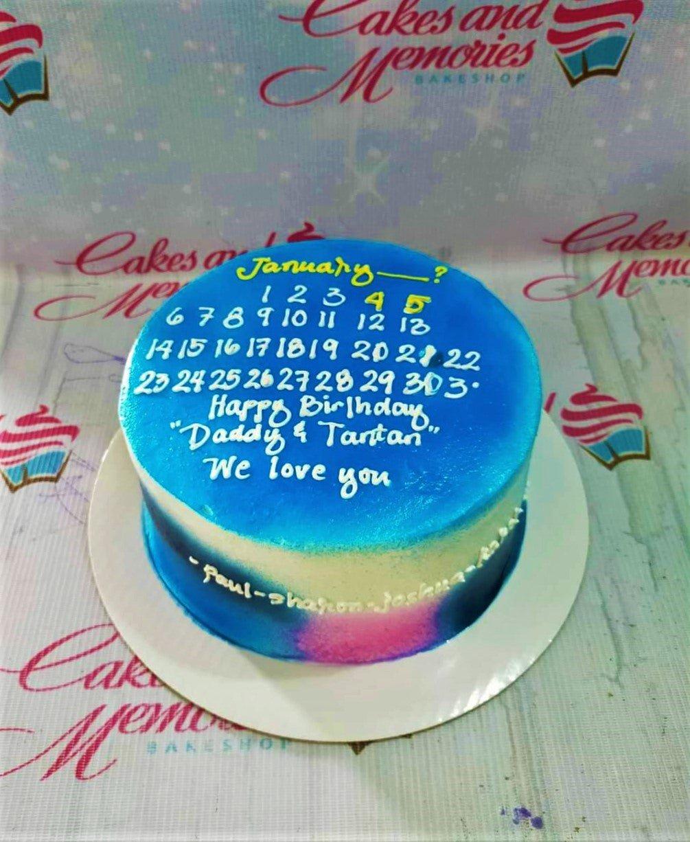 Blue and white minimalist calendar cake with yellow and white icing text for a birthday celebration.