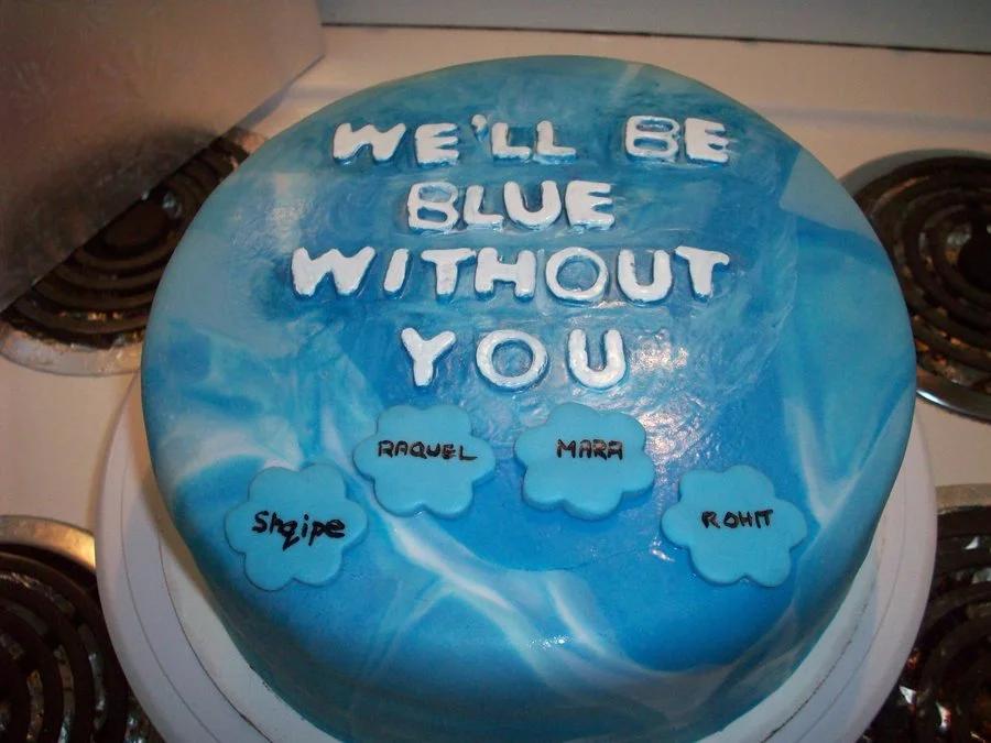 Blue and white marbled fondant cake with 'WE'LL BE BLUE WITHOUT YOU' message and personalized blue flower name tags.