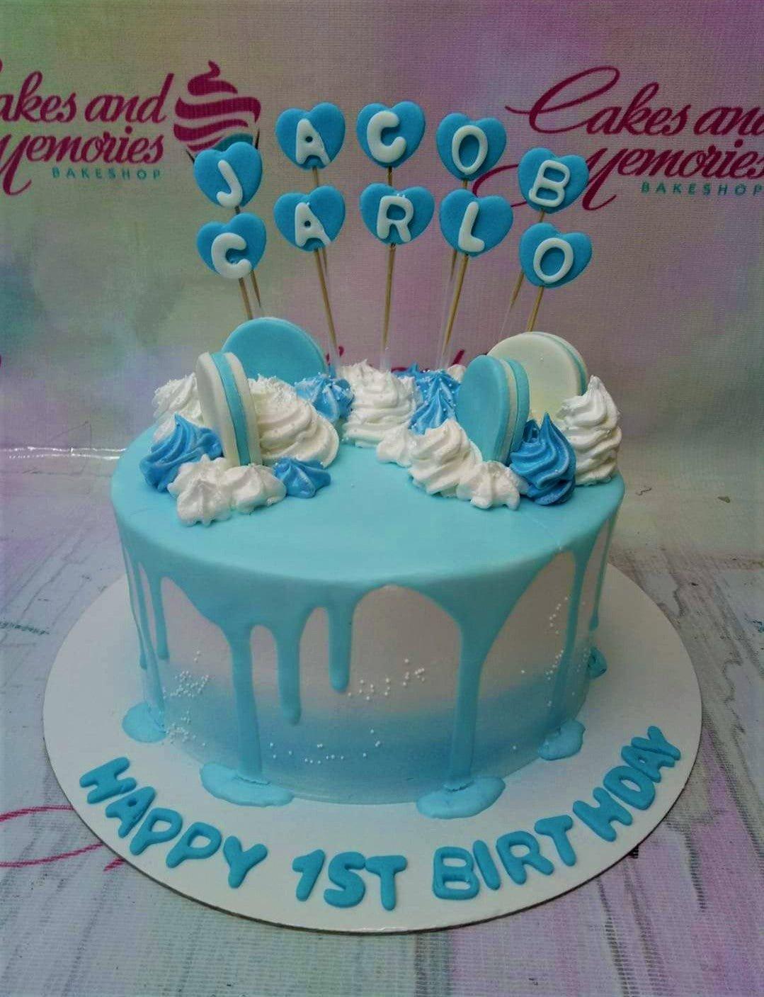 Light blue and white ombre birthday cake with blue heart toppers and white icing dollops