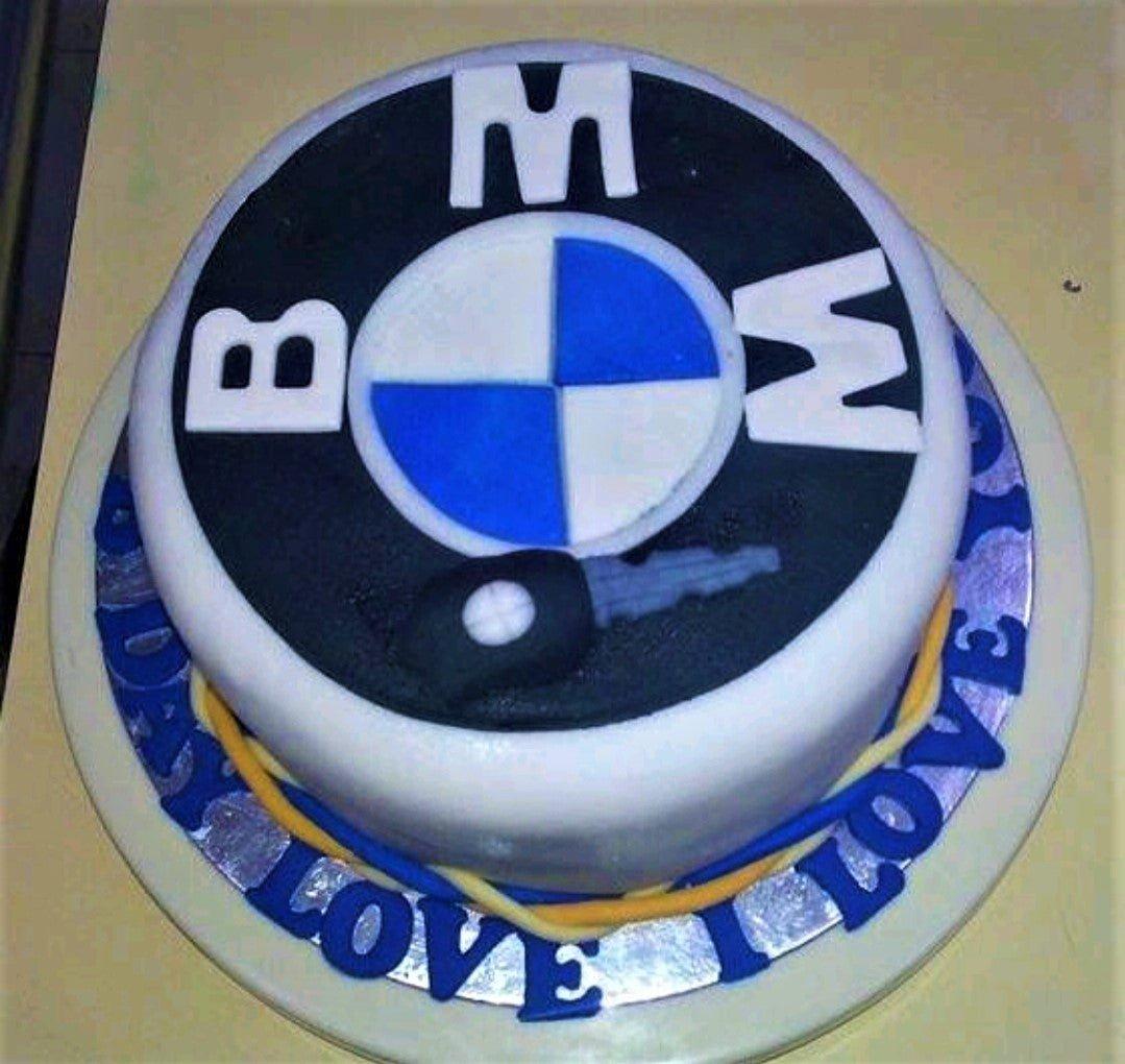BMW logo themed fondant cake with a black and blue logo design and a fondant car key topper.