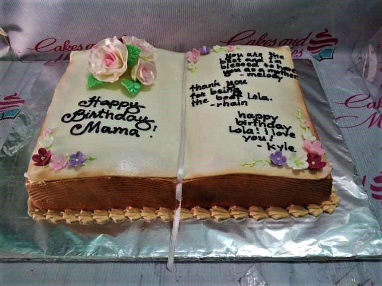 Rectangle book-shaped birthday cake for Mama and Lola with edible pink roses and personalized messages in black icing.