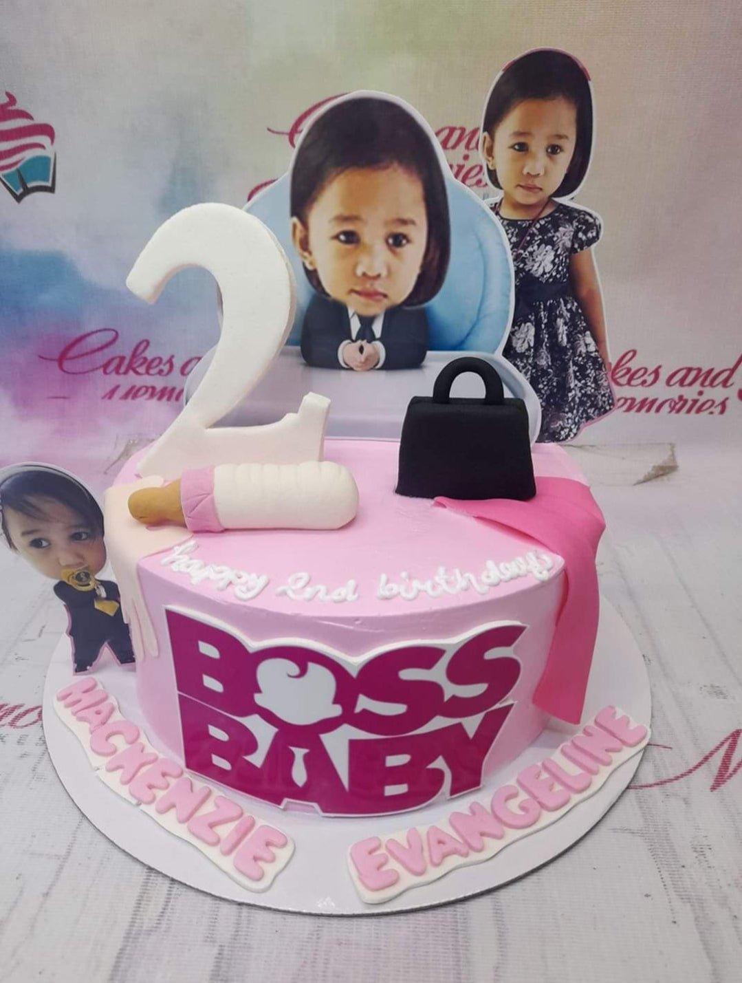 Pink Boss Baby themed birthday cake for Mackenzie Evangeline with photo printouts and fondant baby bottle and bag toppers.