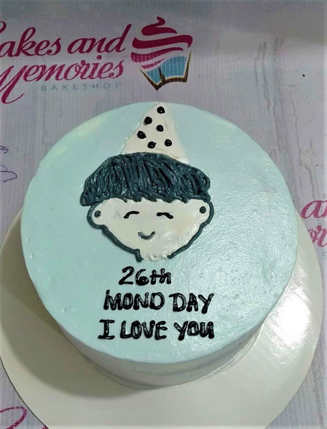 Light blue bento cake with a hand-piped icing doodle of a boy in a party hat and a birthday message.