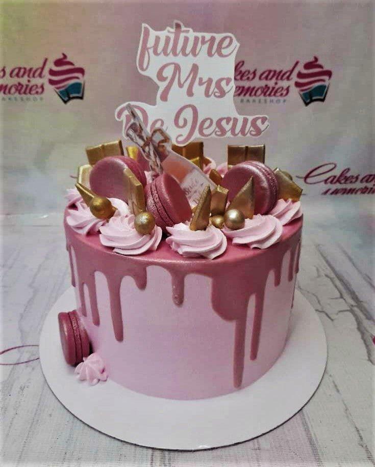 Pink 1-tier cake with pink drip, macarons, gold chocolate bars, and a 'Future Mrs. De Jesus' topper.