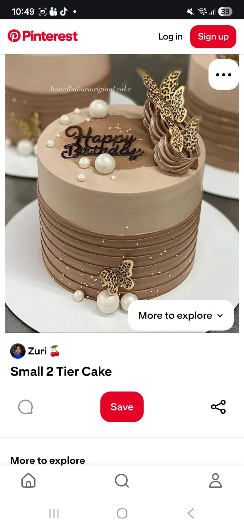 Brown 1-tier birthday cake with leopard print butterflies, white pearls, and chocolate icing swirls.