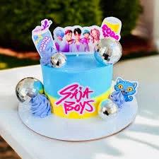 Blue and yellow BTS Saja Boys themed cake with disco balls and character printouts.