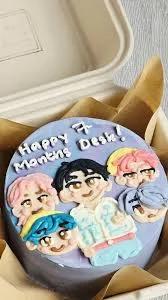 Bento cake with light blue icing featuring hand-piped K-pop boy group characters and a Happy 7 Months Desk message.