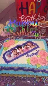 Rectangle K-pop themed birthday cake with edible photo print, pink icing roses, and blue and purple piped borders.