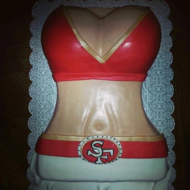 A custom 1-tier fondant cake sculpted into a female torso wearing a red and gold San Francisco 49ers themed bikini top and white skirt.