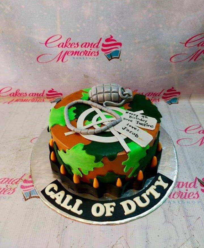 Call of Duty themed camouflage cake with a 3D fondant grenade and dog tags for a 9th birthday celebration.
