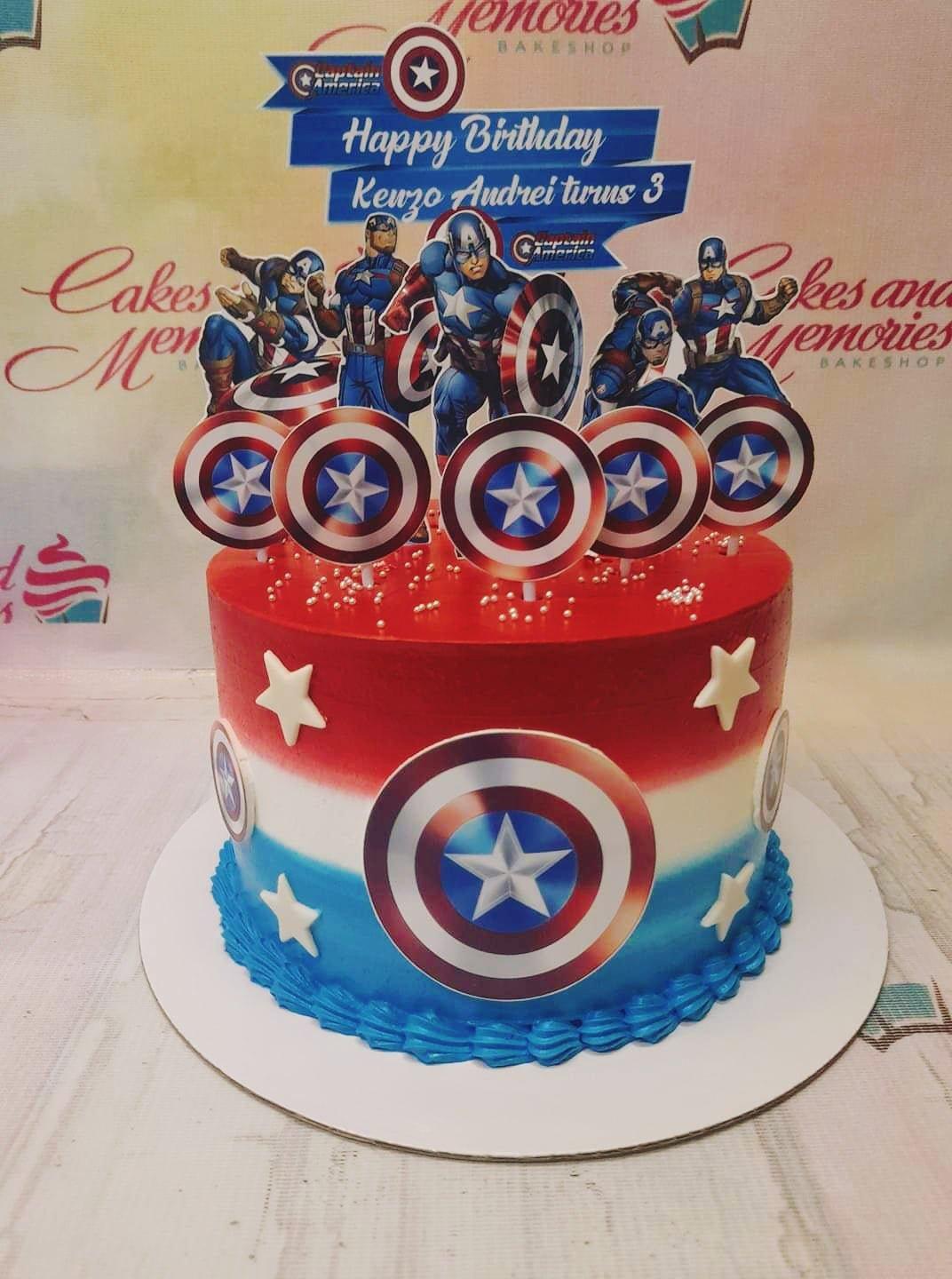 Captain America themed birthday cake with red, white, and blue gradient icing, shield toppers, and silver dragees.