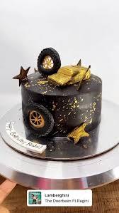 Black and gold luxury car themed cake with edible 3D car and tire toppers and gold splatter design.