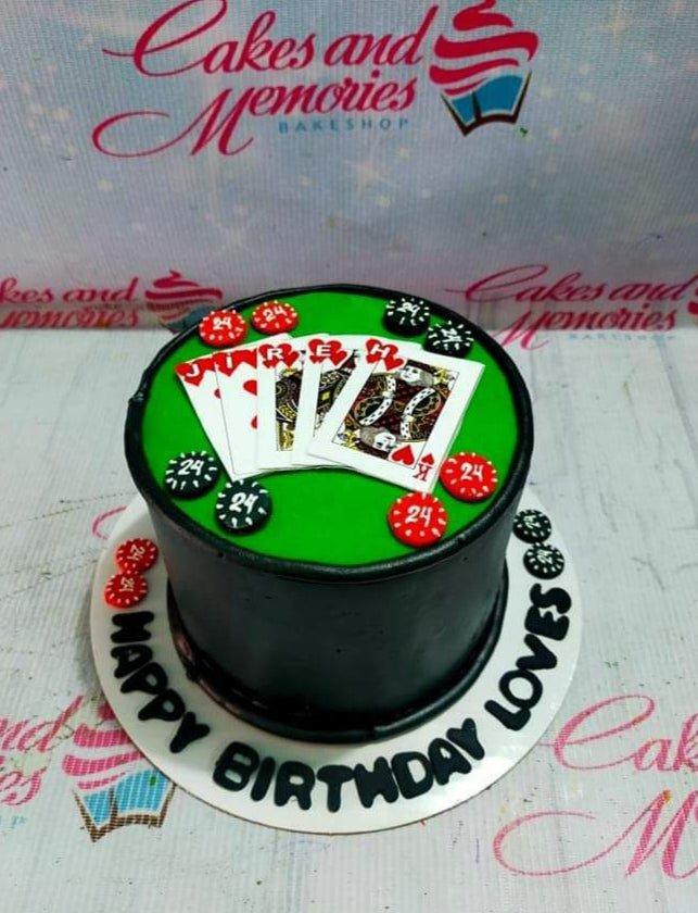 Black casino themed birthday cake with green poker table top, playing cards, and red and black poker chips.