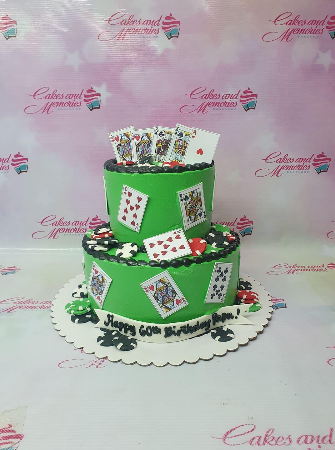Green 2-tier casino themed birthday cake with playing cards and poker chips for a 60th birthday celebration.