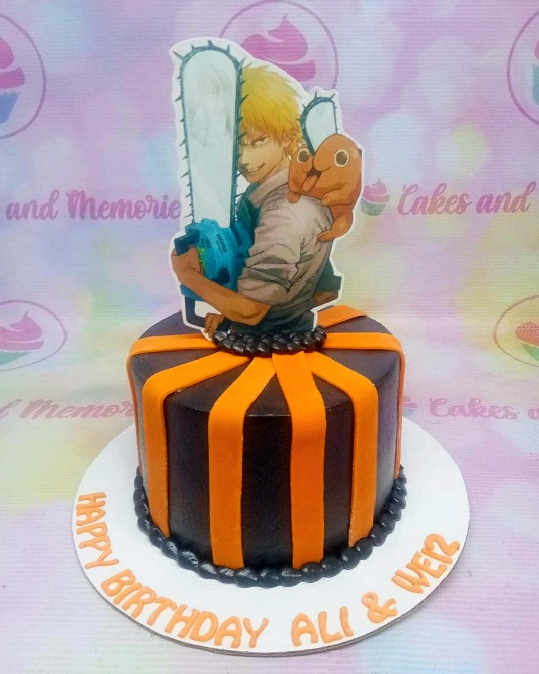 Black and orange Chainsaw Man themed cake with a large character printout and orange fondant stripes.