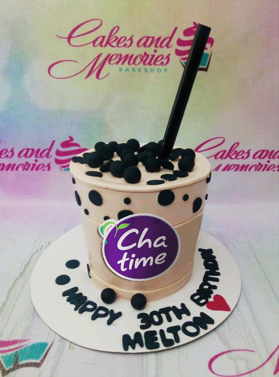 Custom Chatime boba tea cup cake with black fondant pearls and a large black straw topper on a white base board.