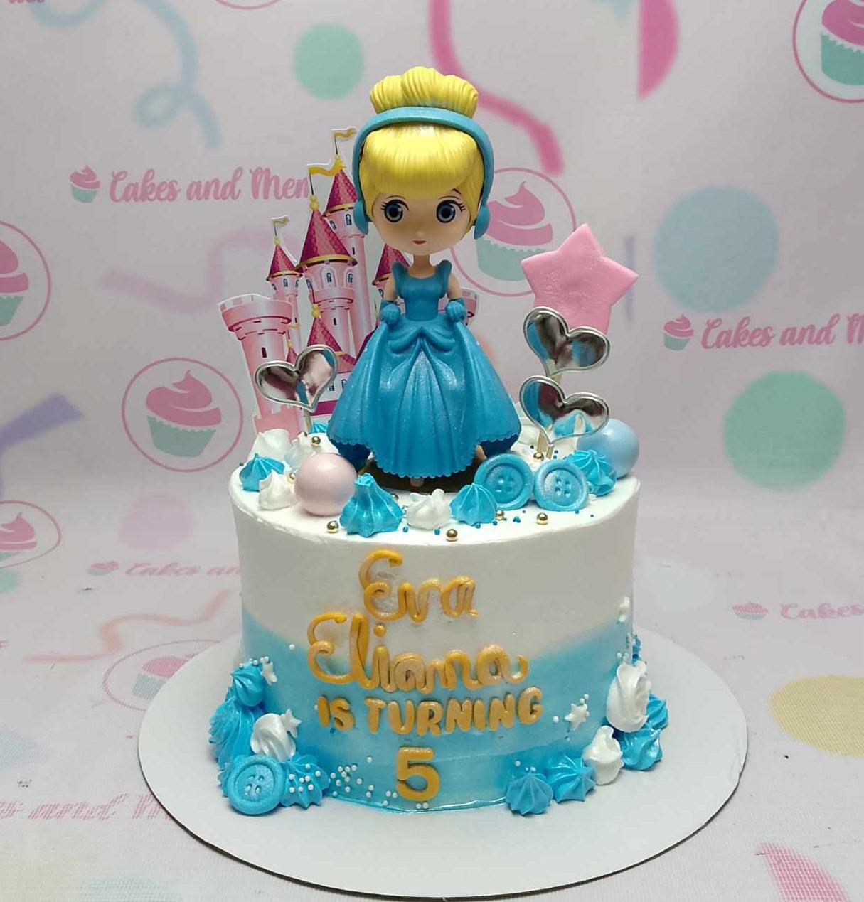 Cinderella themed birthday cake with a blue gradient icing, a princess figurine, and a pink castle printout topper.