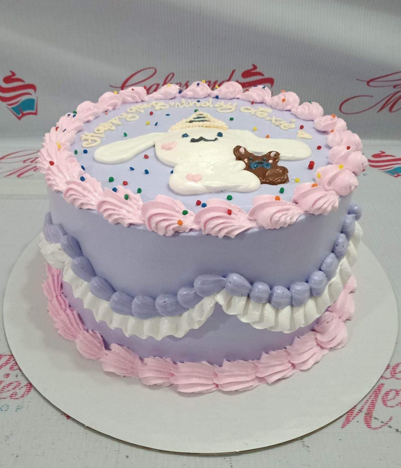 Purple Cinnamoroll birthday cake with pink icing rosettes, white and purple ruffles, and a fondant Cinnamoroll character topper.