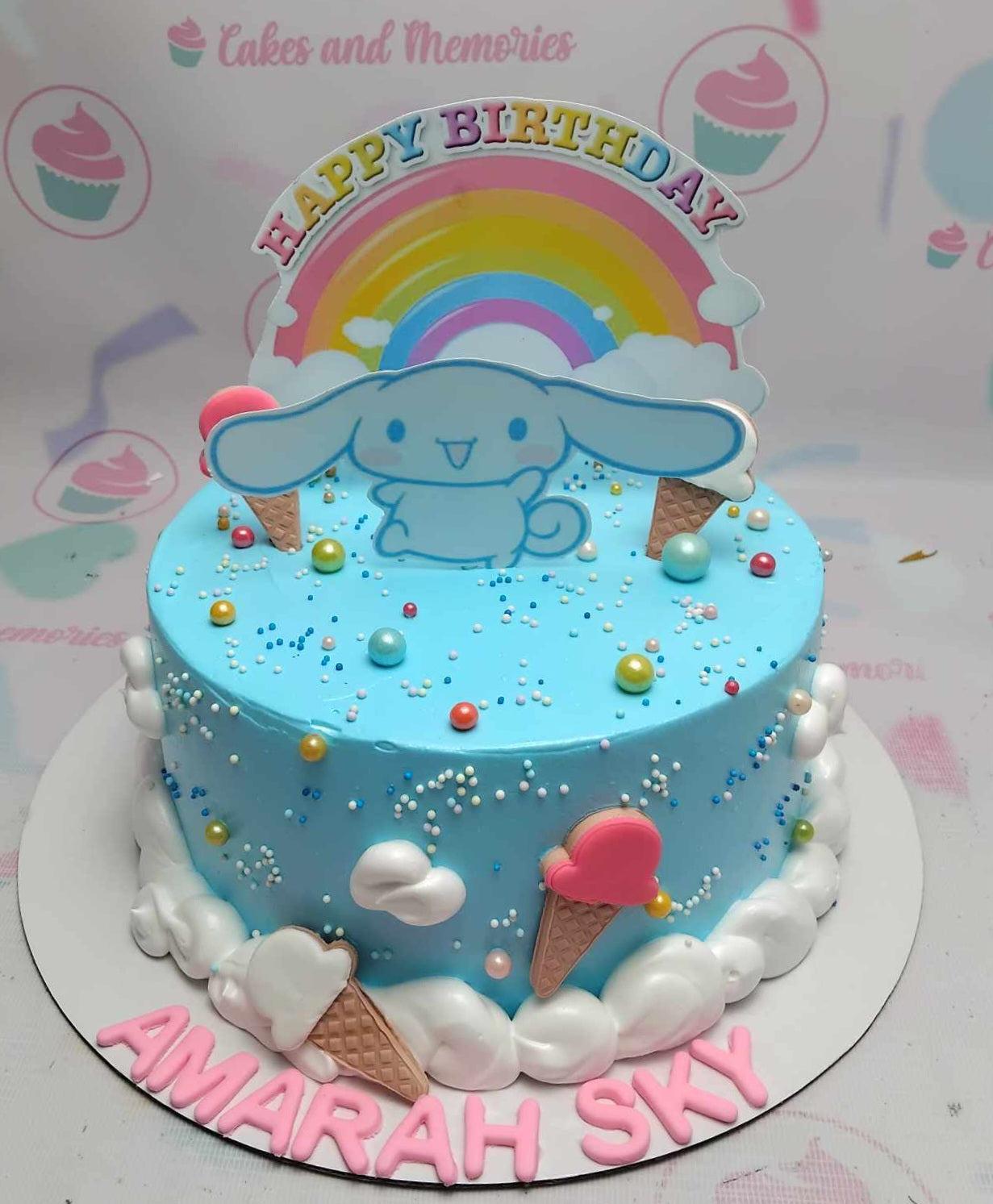 Light blue Cinnamoroll birthday cake with rainbow and cloud toppers, ice cream cones, and colorful sprinkles.