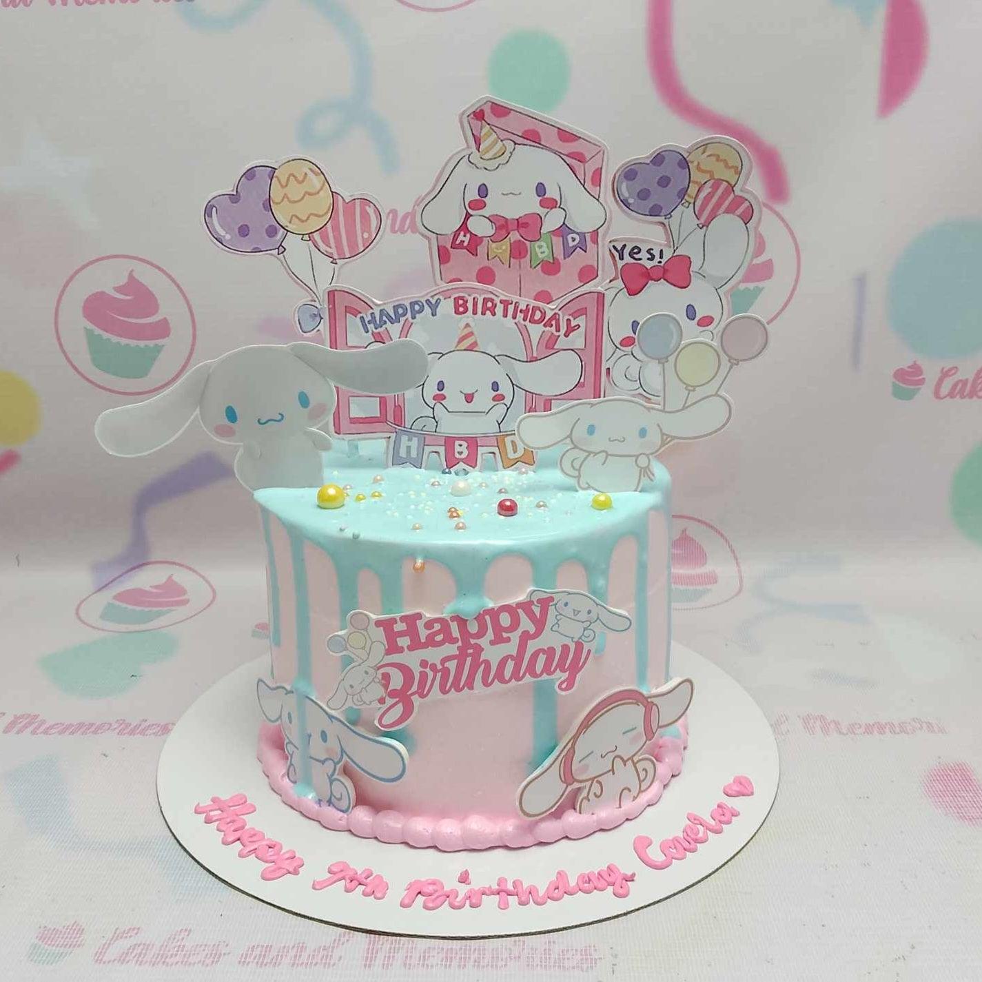 Light blue and pink Cinnamoroll themed birthday cake with character printouts, colorful drips, and sprinkles.