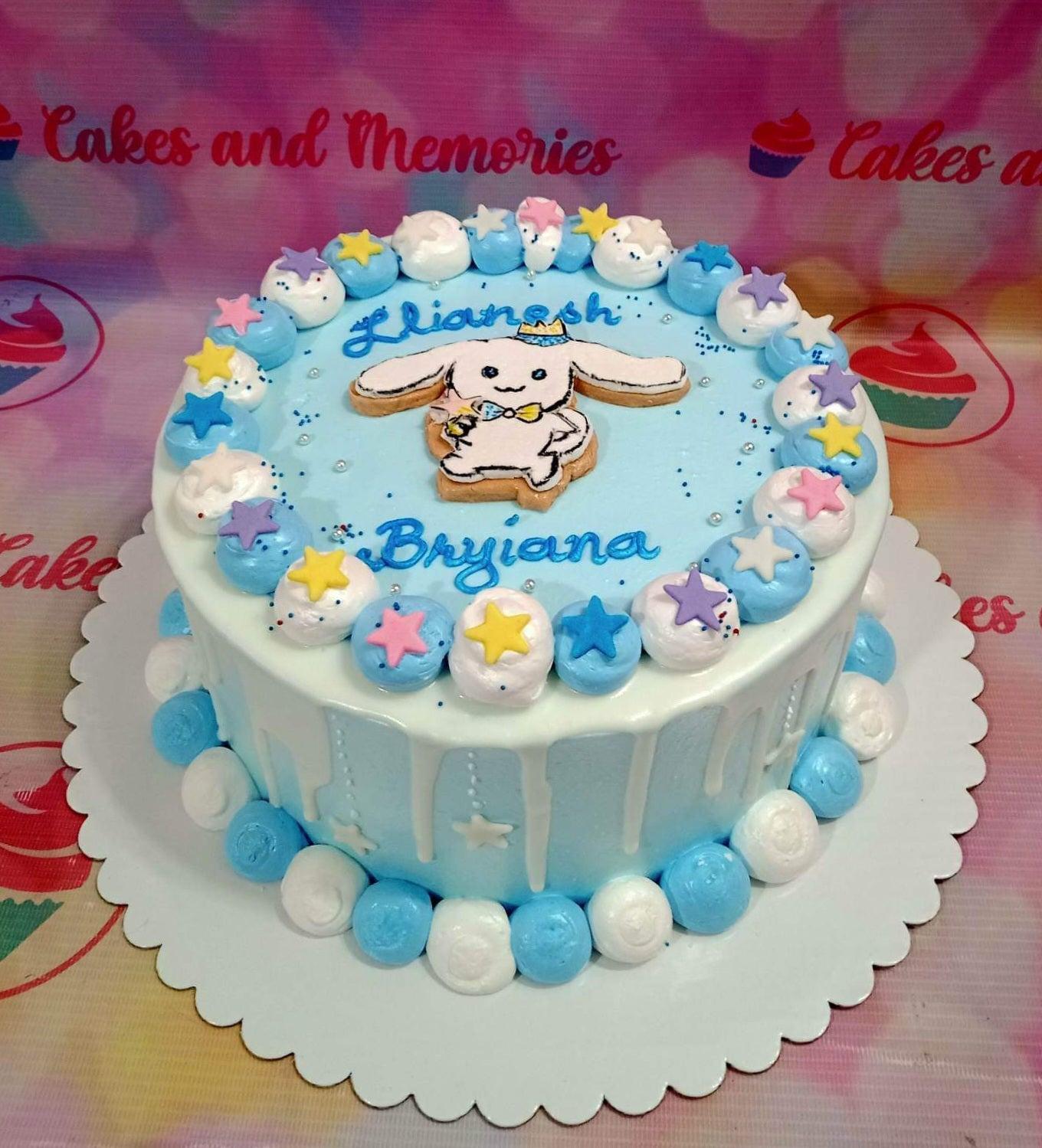 Light blue Cinnamoroll themed birthday cake with white icing drips, colorful fondant stars, and piped icing dollops.