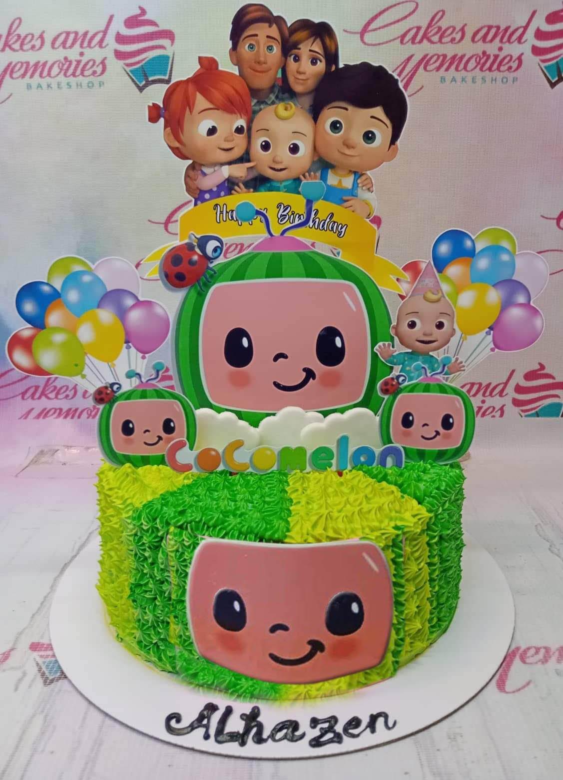 Cocomelon themed birthday cake with green and light green textured icing, featuring printed character toppers and a large Cocomelon face.