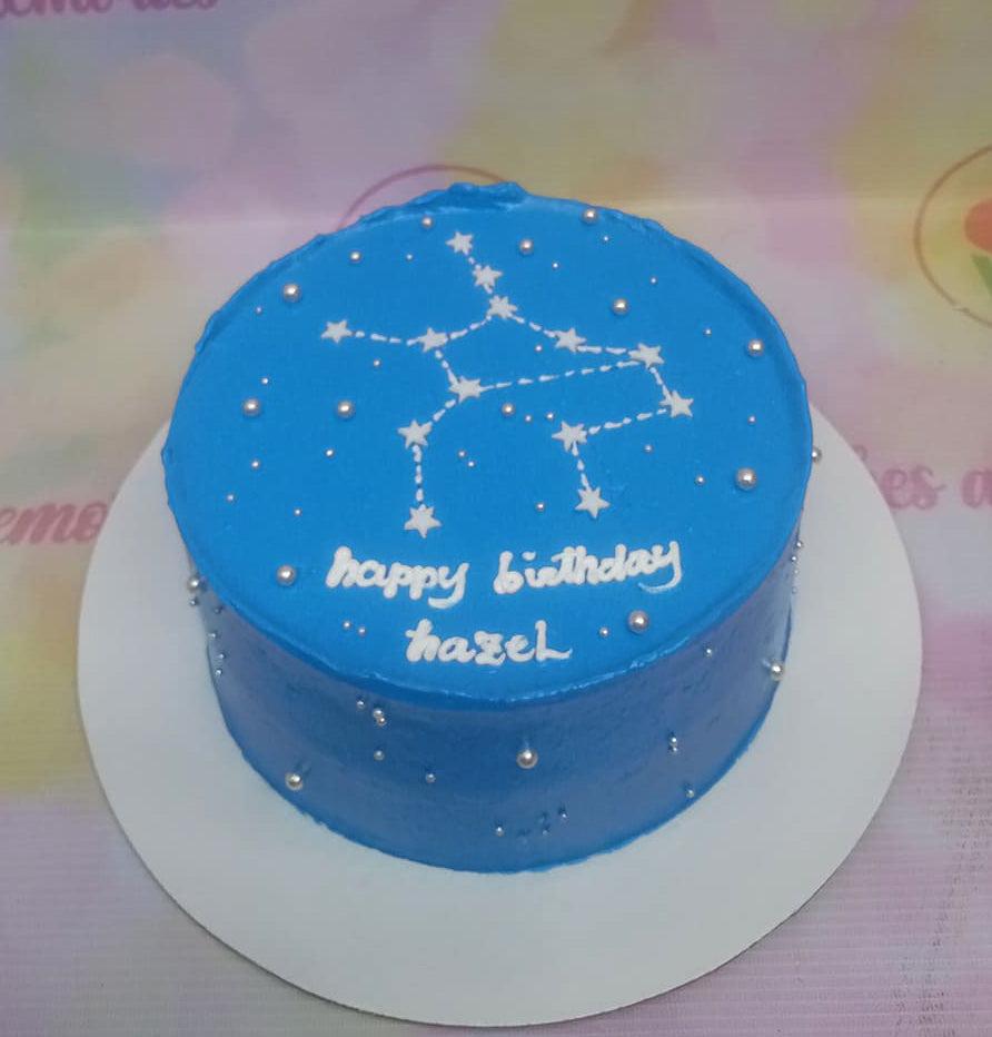 Blue bento cake with white constellation icing design and silver dragees for Hazel's birthday.