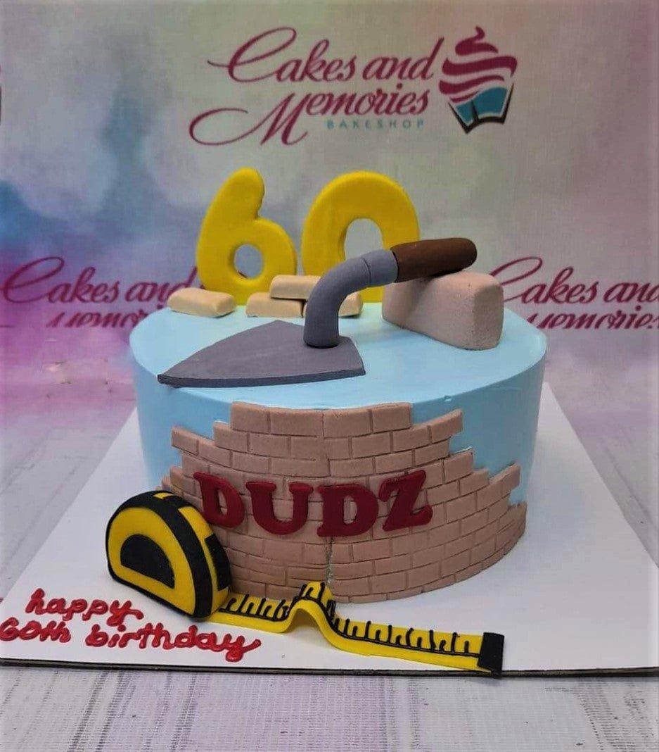 Light blue construction themed cake with fondant brick wall, tape measure, trowel, and yellow number 60 topper.