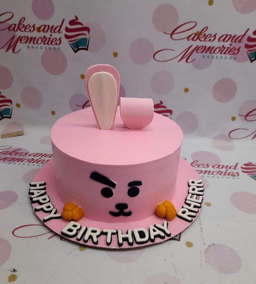 Pink Cooky BT21 character cake with fondant bunny ears and a minimalist face design on pink icing.