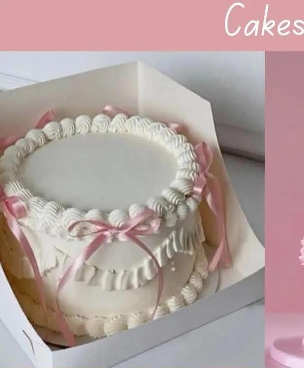 White minimalist cake with pink ribbon bows and piped icing ruffles in a white box
