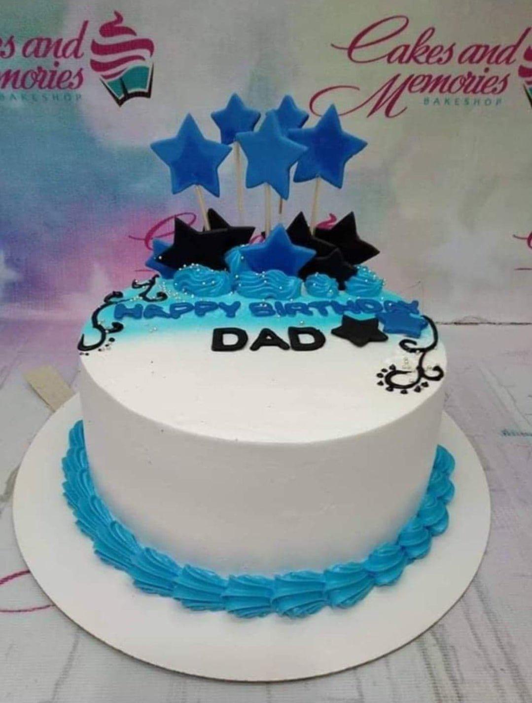 White and blue gradient birthday cake for Dad with blue and black fondant stars and piped icing borders.