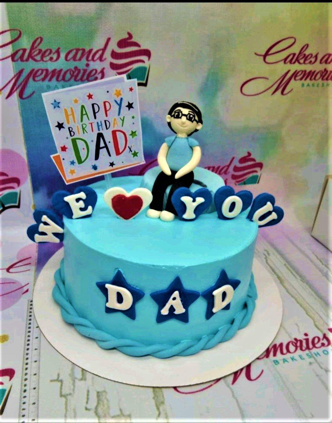 Light blue 1-tier birthday cake for Dad with a fondant male figure, stars, and a Happy Birthday Dad printout topper.