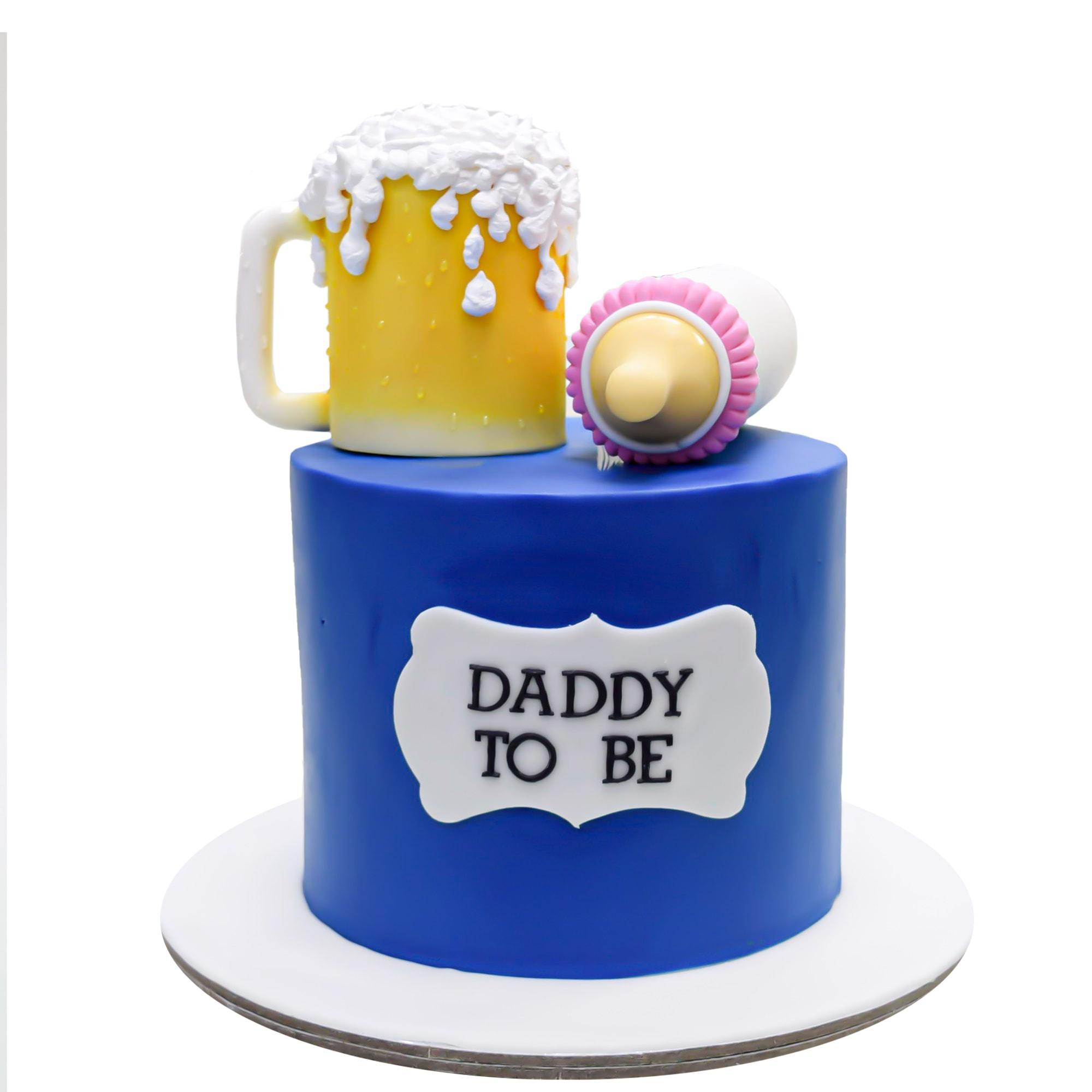 Blue fondant cake for a baby shower featuring a 3D fondant beer mug and baby bottle toppers with a Daddy To Be message.