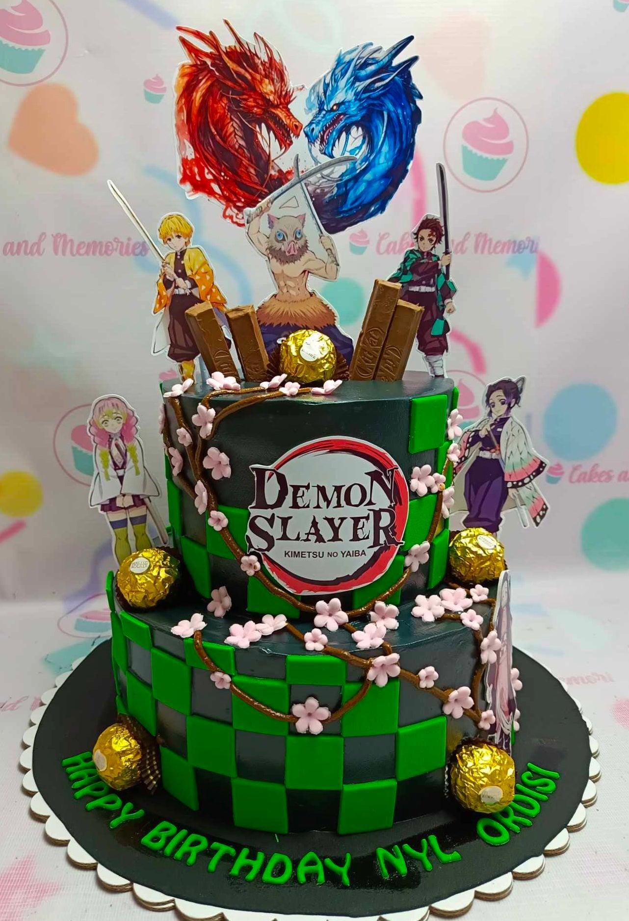 A black 2-tier cake featuring Demon Slayer character printouts, dragon decorations, and green checkered panels.