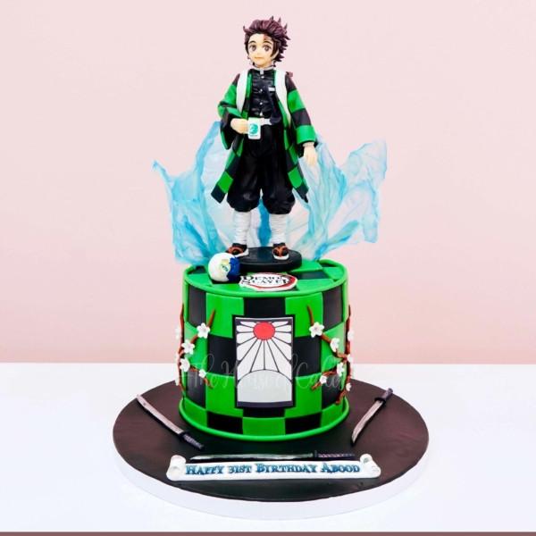 A multicolor 1 tier cake featuring a Tanjiro figure, isomalt water effect, soccer ball, Demon Slayer logo, hanafuda earring panel, cherry blossom branches and katana swords.