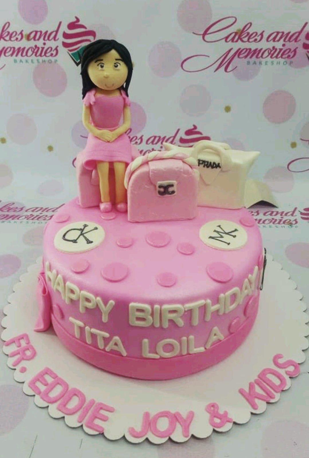 Pink fondant birthday cake for Tita Loila featuring a 3D fondant woman figure and designer handbags like Prada and Chanel.