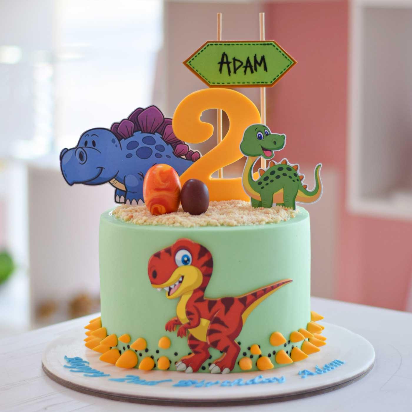 Cake 1 Tier - yellow, green, blue theme with yellow number 2 and red T-Rex dinosaur