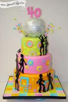 Vibrant 3-tier disco themed 40th birthday cake with a silver disco ball topper, black dancer silhouettes, and colorful retro patterns.