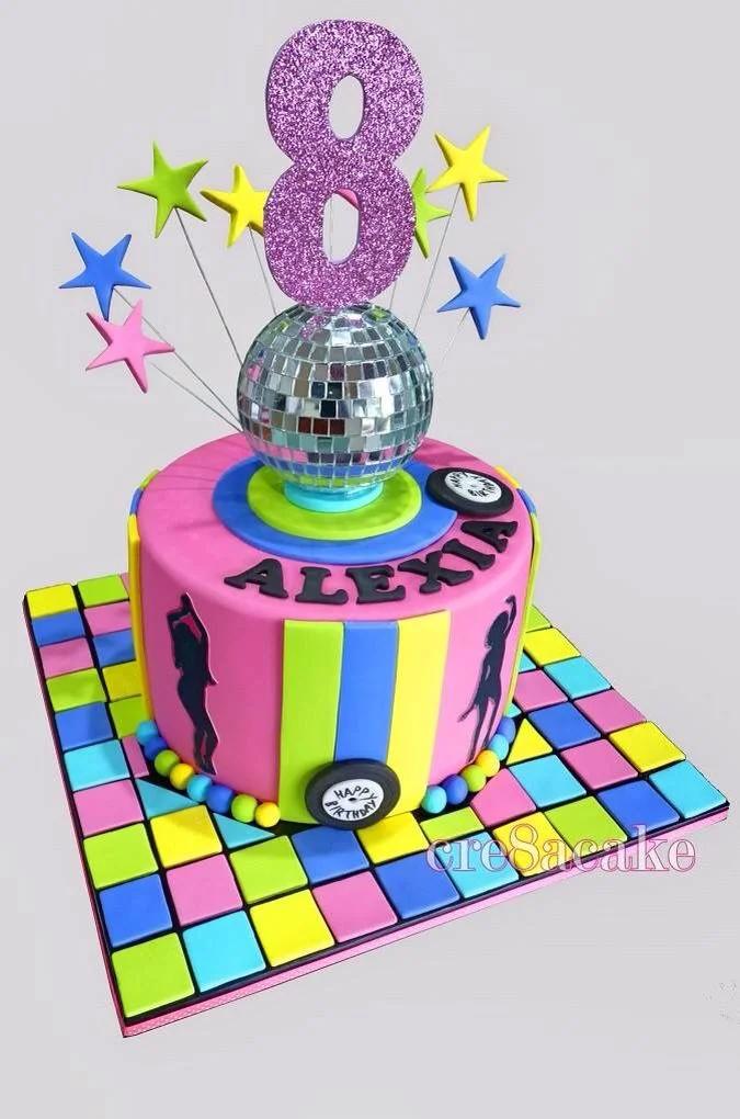 Vibrant pink disco themed birthday cake for Alexia's 8th birthday featuring a silver disco ball, glittery number 8, and colorful star toppers.