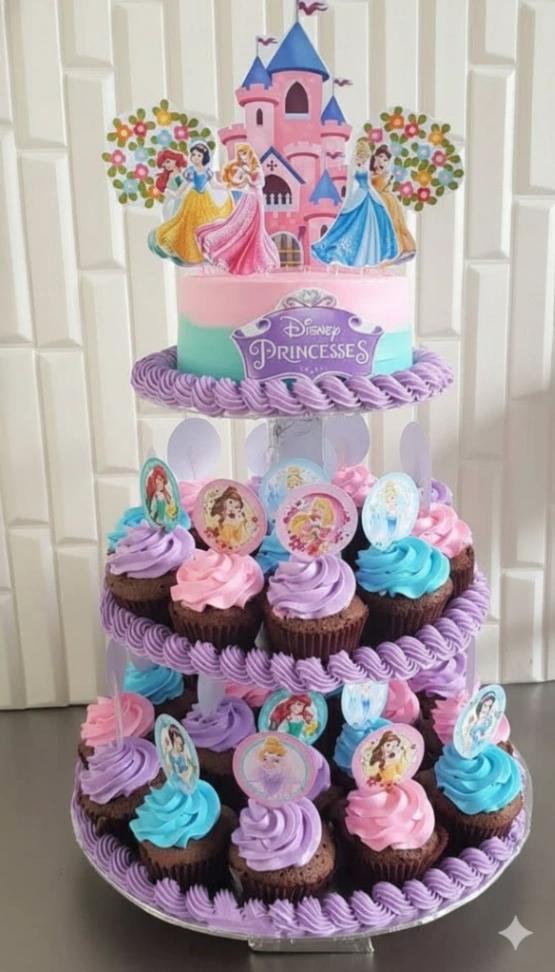 Disney Princess themed cake with a pink and teal gradient icing, purple rope borders, and a large castle printout topper.